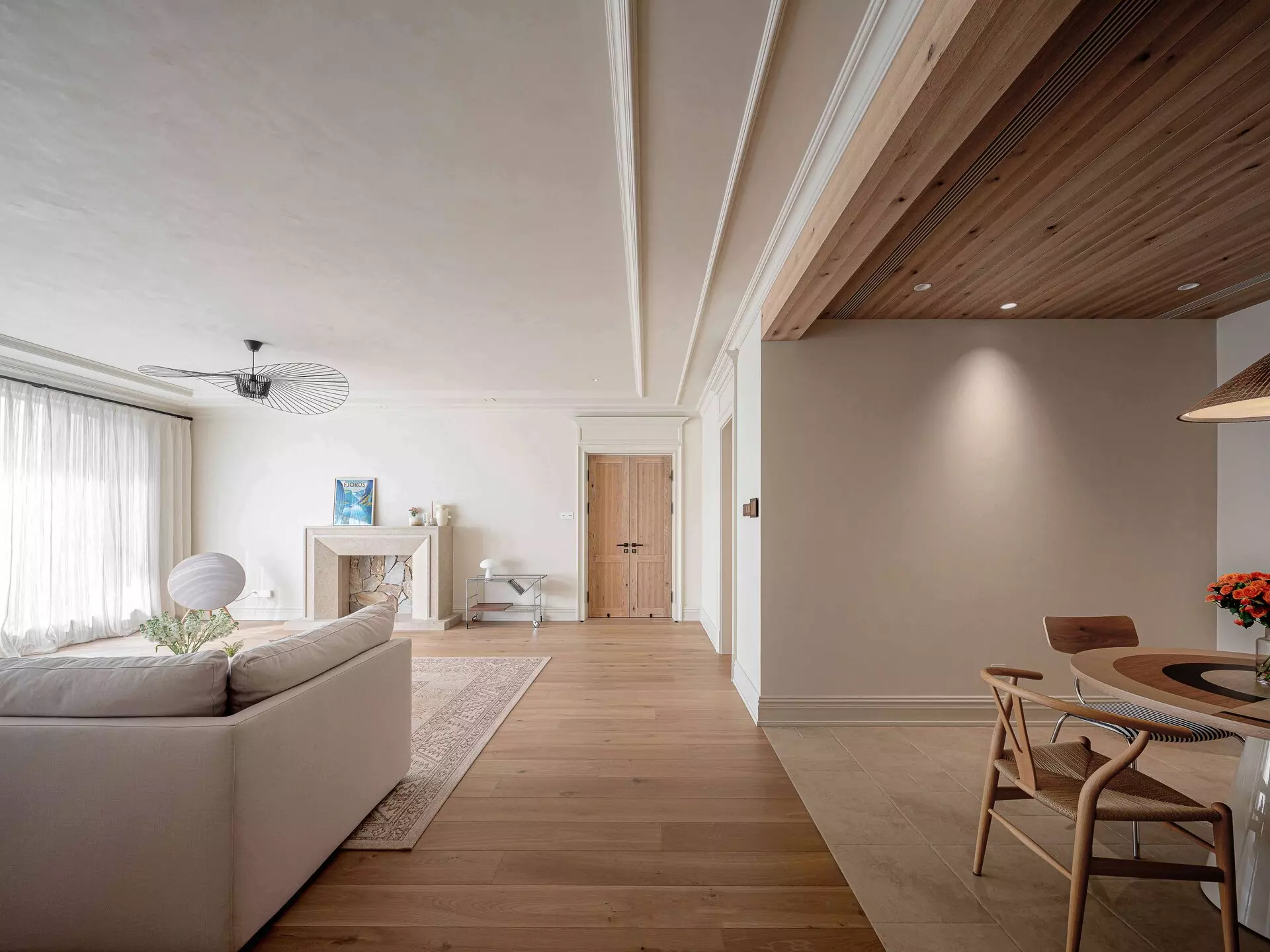 Seamless Transition from Living Room to Dining Area with Custom Wood Ceiling Panel