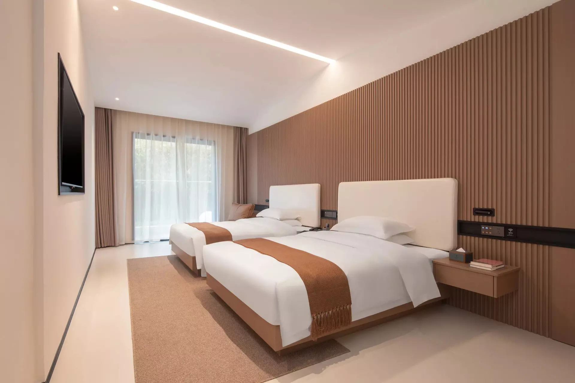 Luxury hotel suite bedroom with custom integrated wood headboard paneling